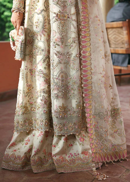 Ethereal ivory frost suit with hand-embellished organza panels, ornate borders, embroidered dupatta, and printed trouser for timeless elegance.