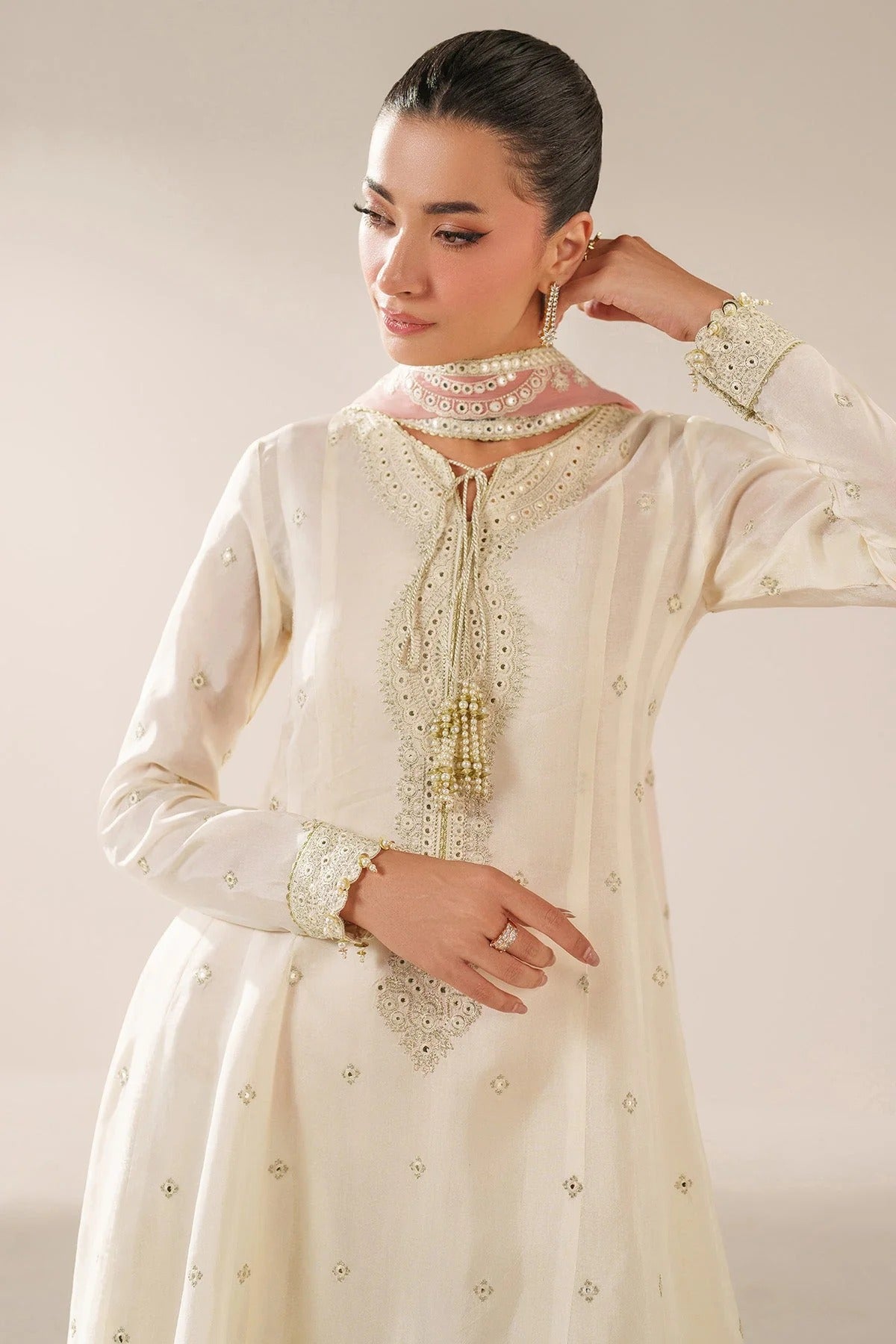 Digitally printed chiffon suit with embroidery on yoke, panels, sleeves & dupatta. Paired with dyed rawsilk bottom for a luxe, elegant formal look.
