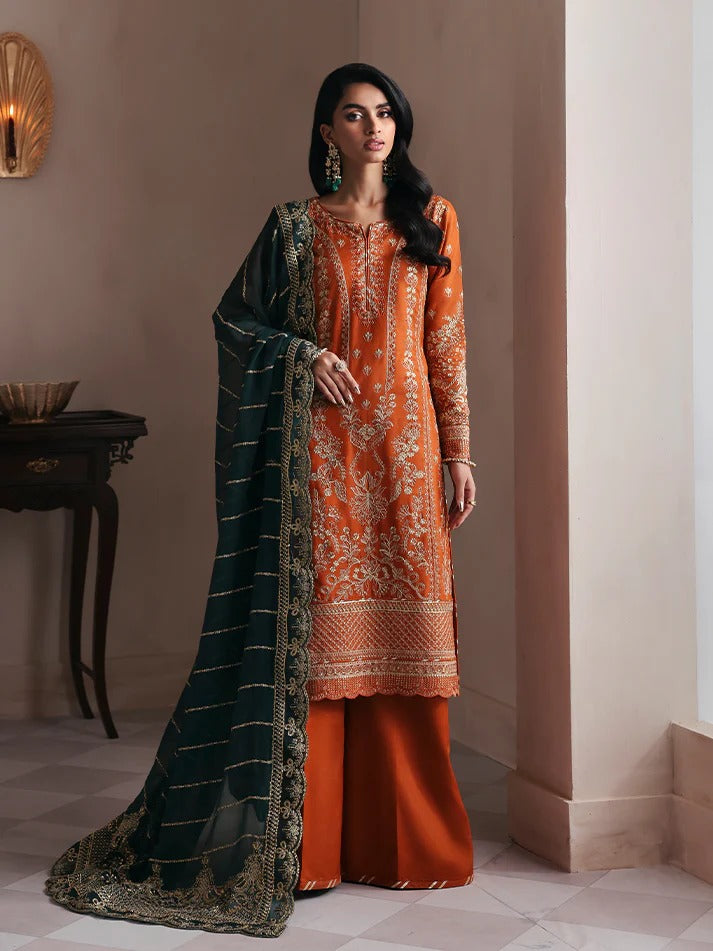 Grace your wardrobe with this embroidered and sequined raw silk outfit featuring detailed panels, chiffon dupatta with organza border, and dyed silk trousers.