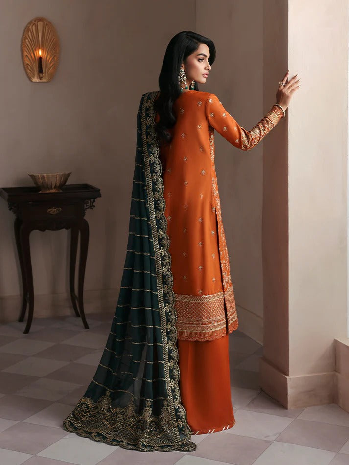 Grace your wardrobe with this embroidered and sequined raw silk outfit featuring detailed panels, chiffon dupatta with organza border, and dyed silk trousers.