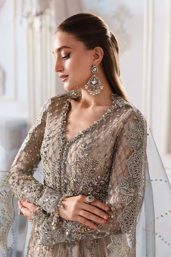 Elegant net ensemble with hand-embellished bodice, organza dupatta, and raw silk base. Perfect for weddings and formal wear. Color may slightly vary.