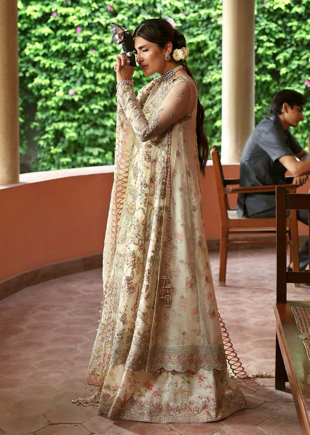 Ethereal ivory frost suit with hand-embellished organza panels, ornate borders, embroidered dupatta, and printed trouser for timeless elegance.