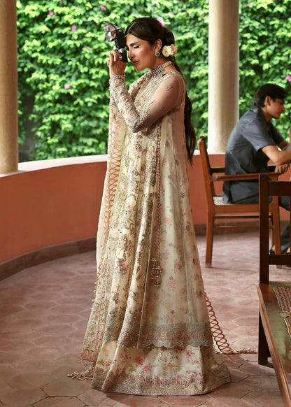 Ethereal ivory frost suit with hand-embellished organza panels, ornate borders, embroidered dupatta, and printed trouser for timeless elegance.