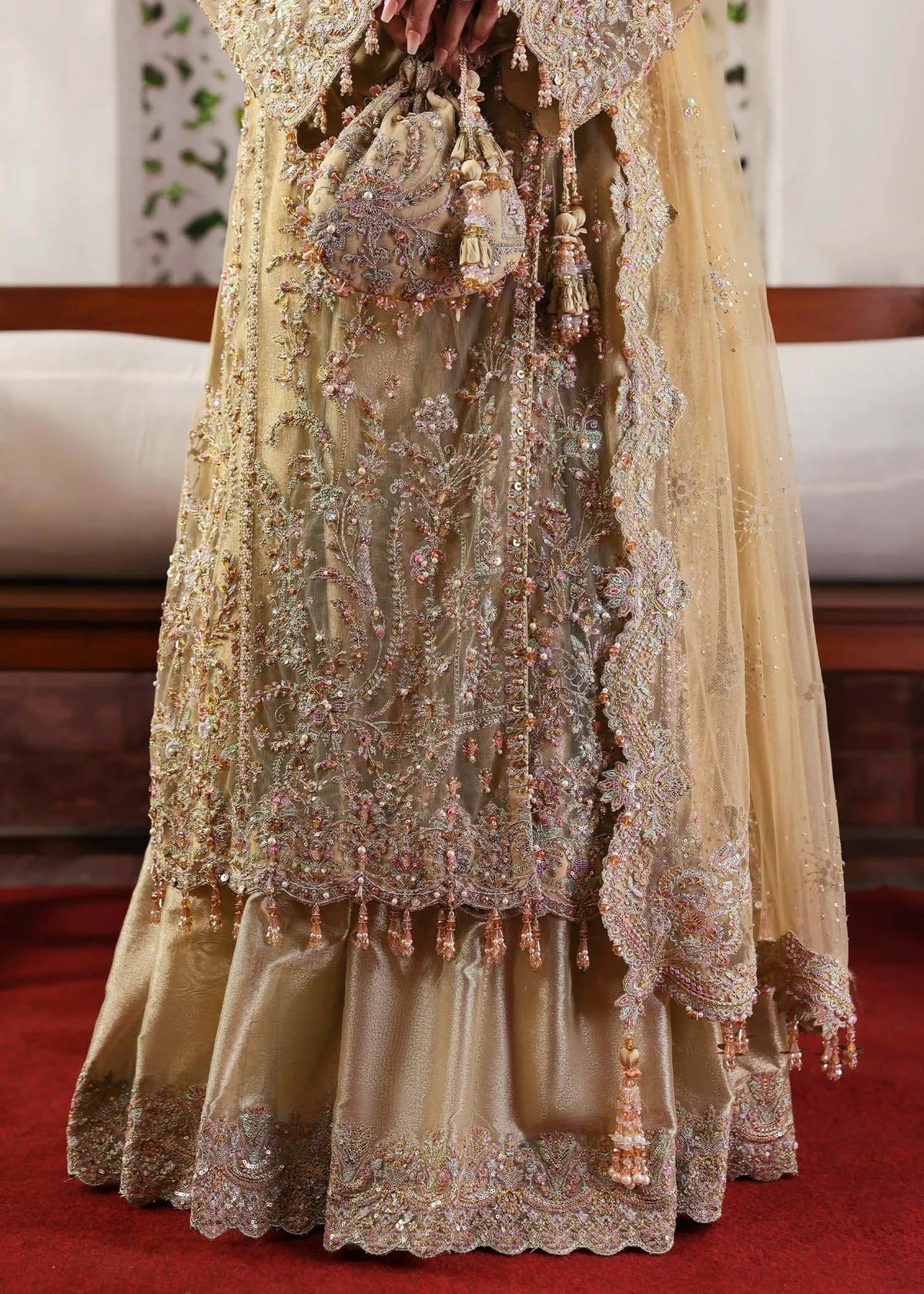 Elegant champagne beige suit with hand-embellished net panels, ornate borders, embroidered dupatta, and trouser for timeless festive sophistication.