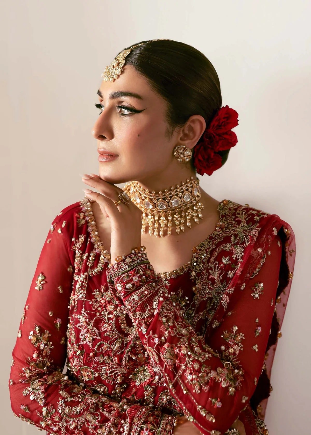 Regal crimson lehenga with hand-embellished panels, ornate borders, embroidered dupatta, and net body—perfect for festive and wedding elegance.