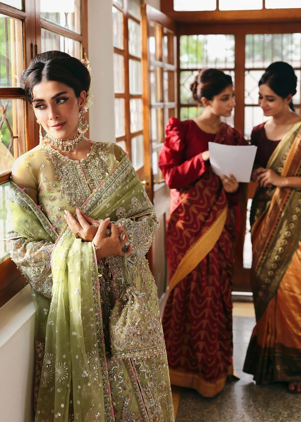 Vibrant parrot jade suit with hand-embellished organza panels, embroidered dupatta, and printed trouser—perfect for festive elegance.