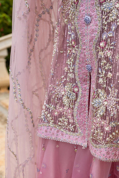Stylish light pink dress with embroidered net shirt, sequined dupatta, embellished trouser, silk neckline, and handmade tassels for an elegant look.