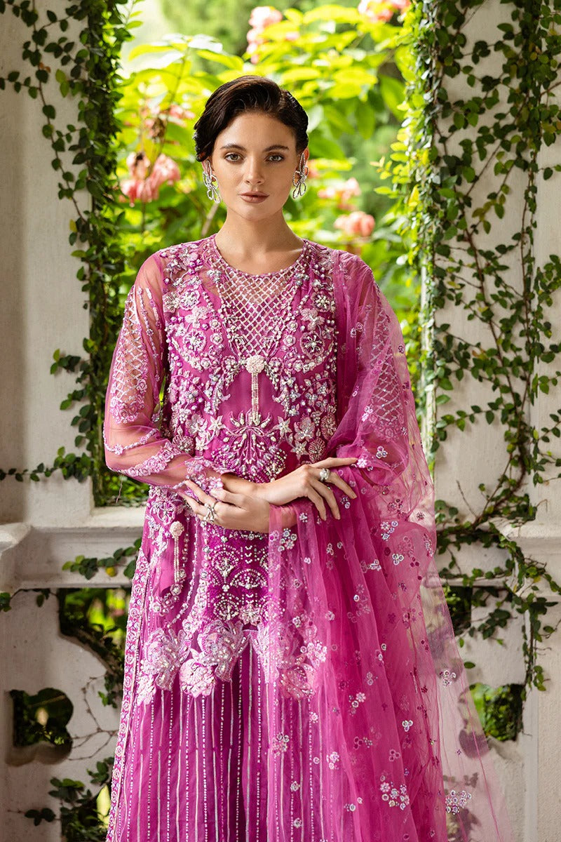 Graceful blush pink dress with embroidered net shirt, sequined dupatta, raw silk trouser, pearl-detailed daman border, and handmade tassels.