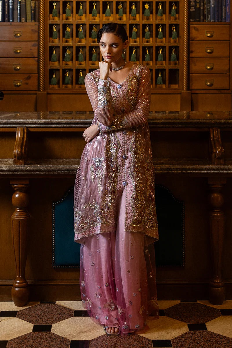 Stylish light pink dress with embroidered net shirt, sequined dupatta, embellished trouser, silk neckline, and handmade tassels for an elegant look.