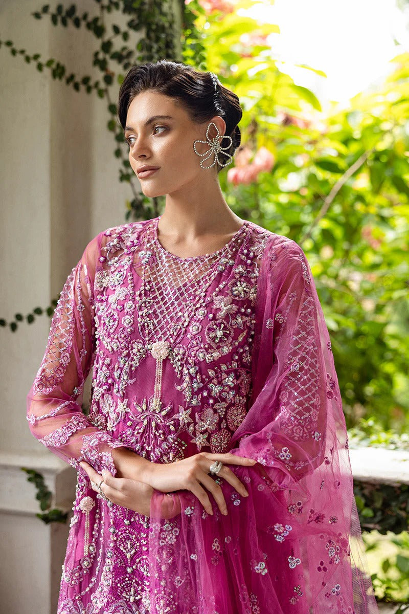 Graceful blush pink dress with embroidered net shirt, sequined dupatta, raw silk trouser, pearl-detailed daman border, and handmade tassels.