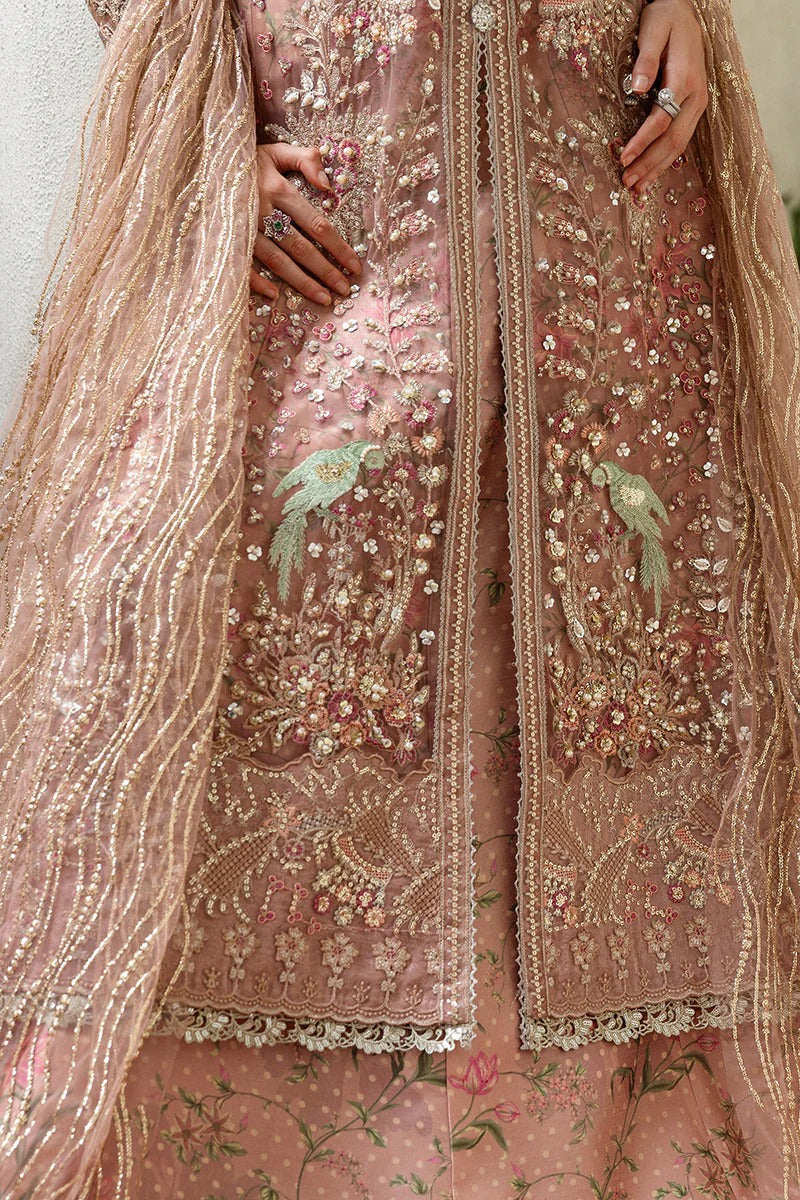 Elegant coral pink lehenga with embroidered net shirt, sequined dupatta, hand embellishments, and handmade tassels for a luxurious festive look.