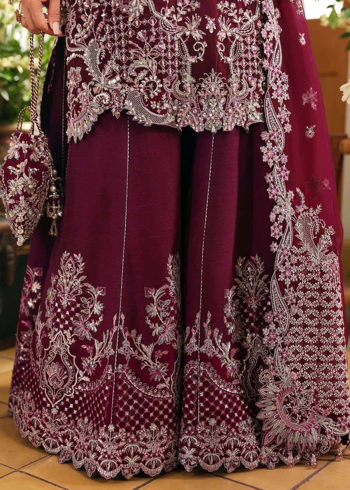 Regal imperial plum suit with hand-embellished organza panels, ornate borders, embroidered dupatta, and trouser for timeless festive elegance.