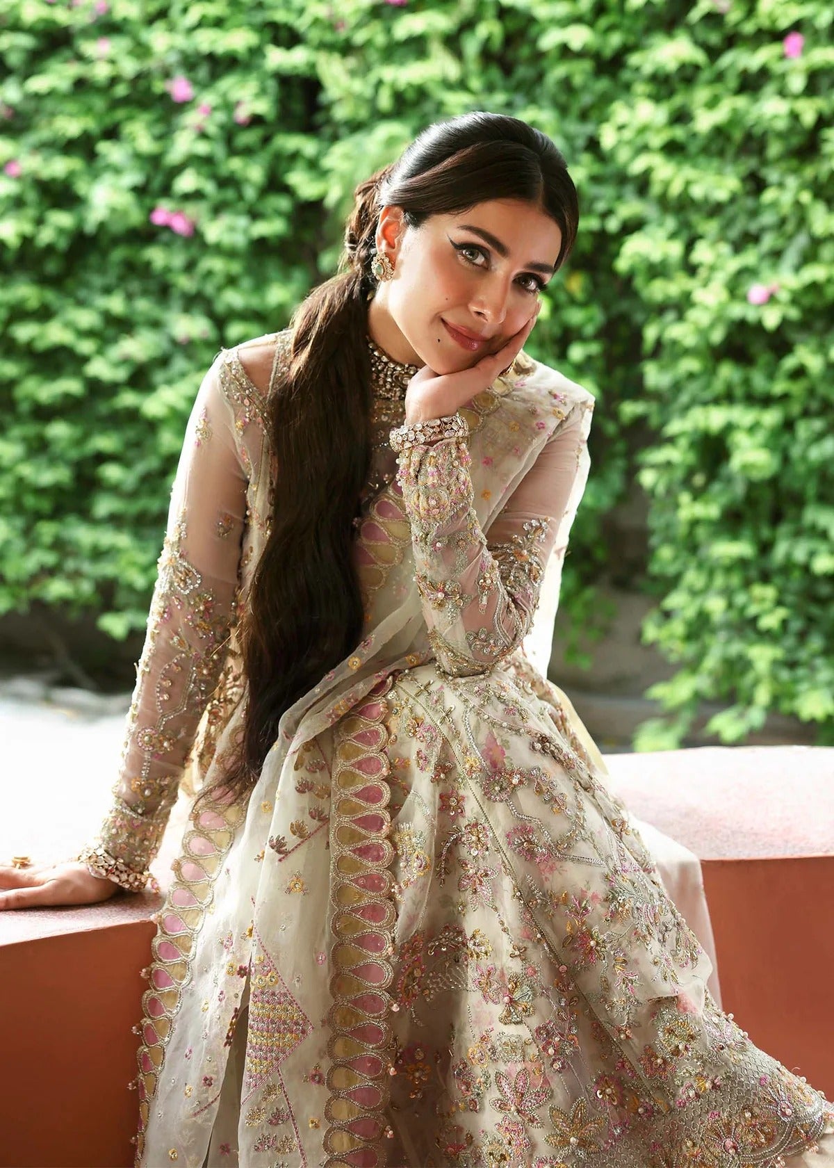 Ethereal ivory frost suit with hand-embellished organza panels, ornate borders, embroidered dupatta, and printed trouser for timeless elegance.