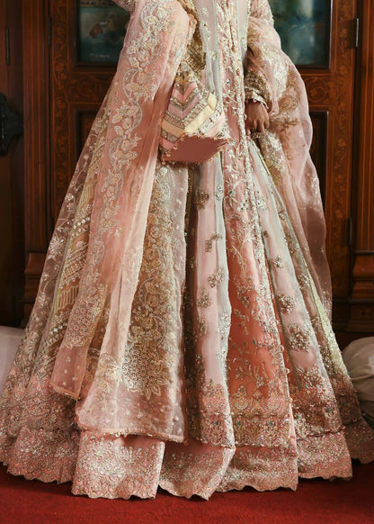 Stunning jewel-toned lehenga suit with hand-embellished shirt, embroidered borders, and organza dupatta for a regal festive look.