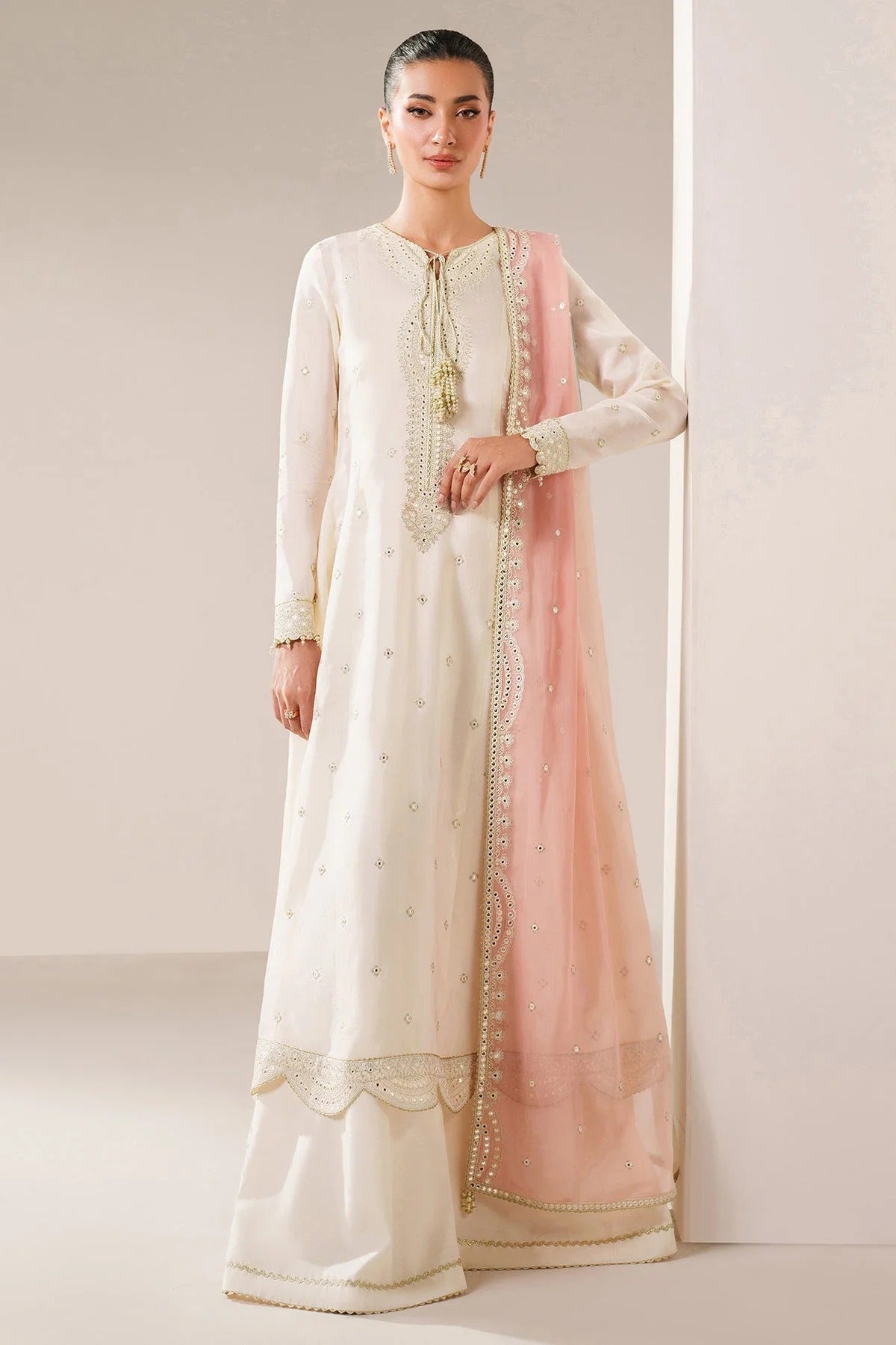 Digitally printed chiffon suit with embroidery on yoke, panels, sleeves & dupatta. Paired with dyed rawsilk bottom for a luxe, elegant formal look.