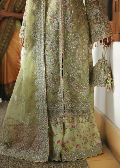 Vibrant parrot jade suit with hand-embellished organza panels, embroidered dupatta, and printed trouser—perfect for festive elegance.