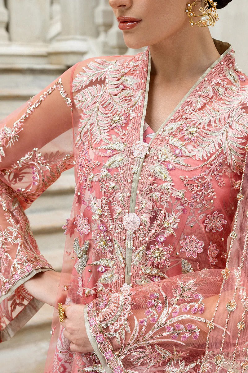 Elegant coral dress with embroidered net shirt, sequined dupatta, raw silk trouser, 3D bird embellishments, and handmade tassels for luxury style.