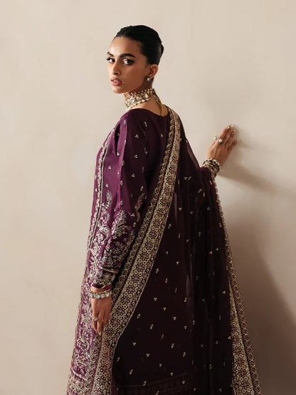 Luxurious raw silk outfit featuring embroidered and sequined panels, elegant chiffon dupatta with organza motifs, and matching dyed silk trouser.