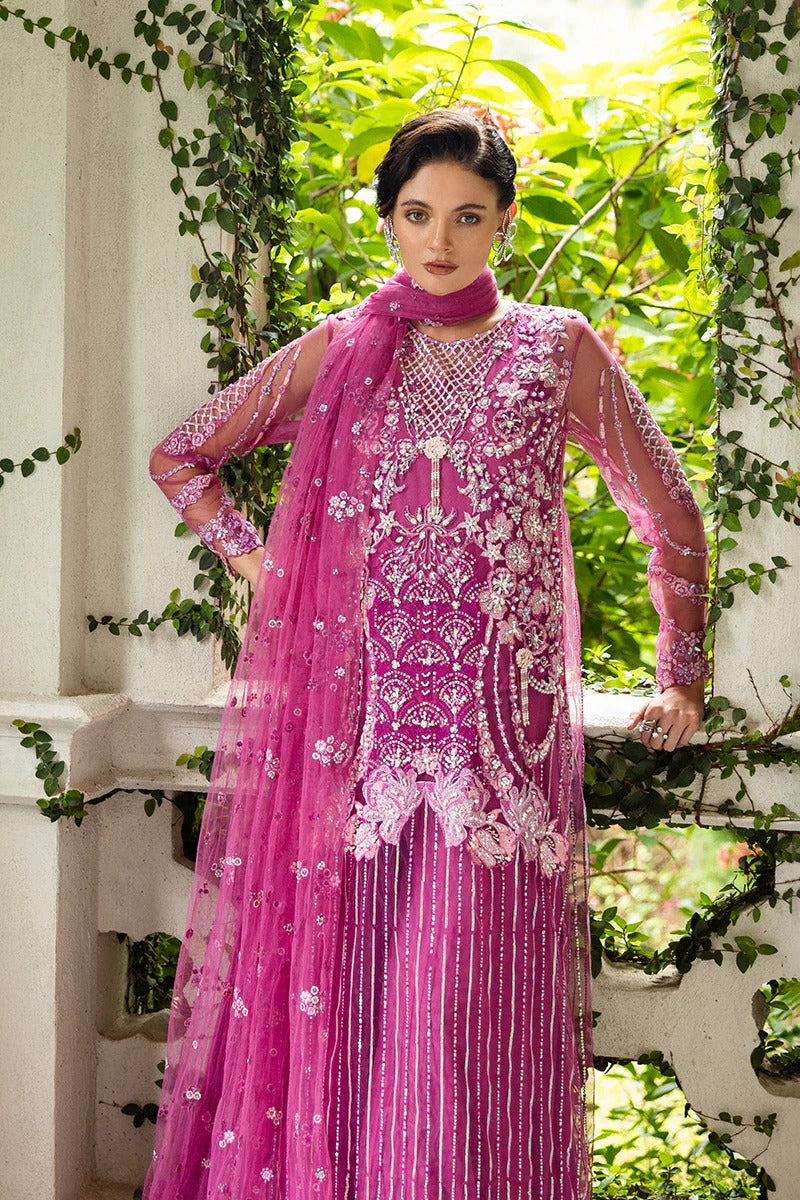 Graceful blush pink dress with embroidered net shirt, sequined dupatta, raw silk trouser, pearl-detailed daman border, and handmade tassels.