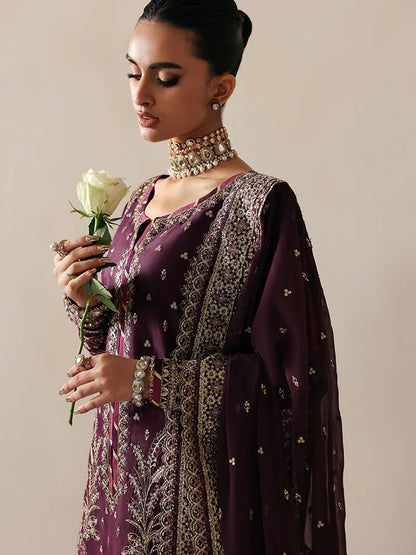 Luxurious raw silk outfit featuring embroidered and sequined panels, elegant chiffon dupatta with organza motifs, and matching dyed silk trouser.