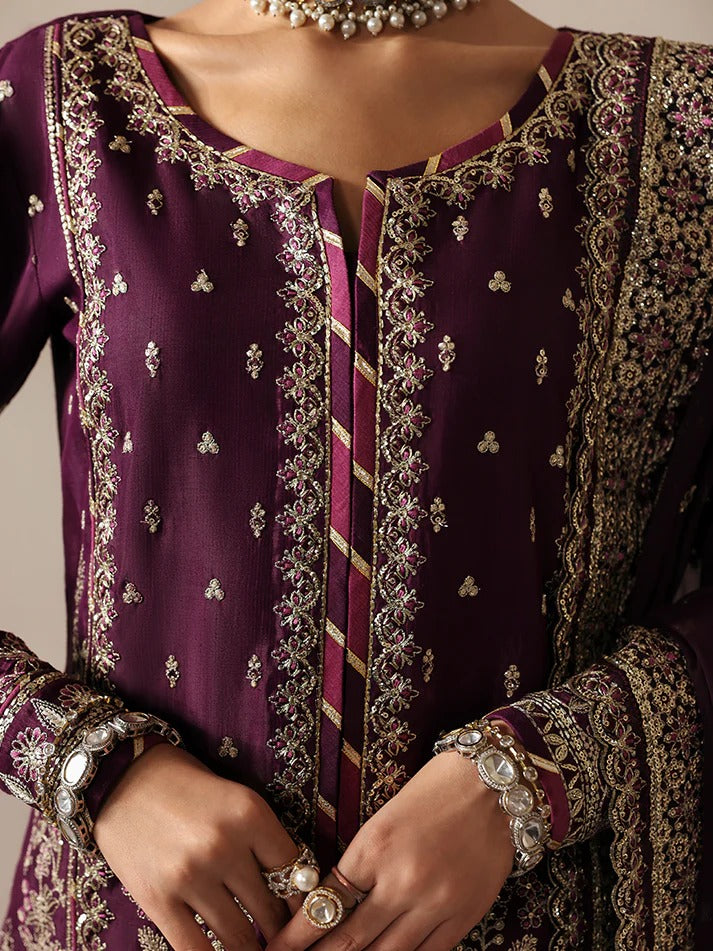 Luxurious raw silk outfit featuring embroidered and sequined panels, elegant chiffon dupatta with organza motifs, and matching dyed silk trouser.