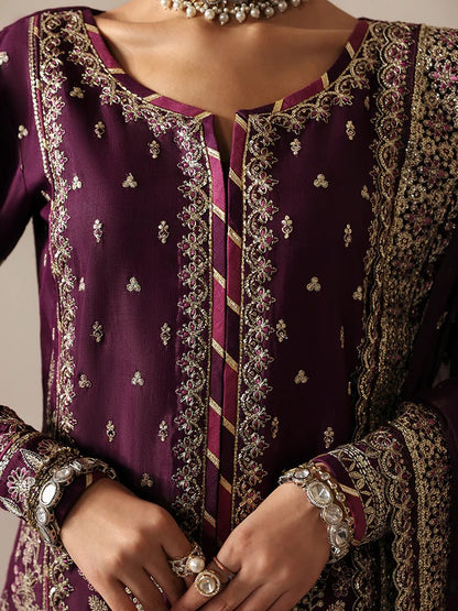 Luxurious raw silk outfit featuring embroidered and sequined panels, elegant chiffon dupatta with organza motifs, and matching dyed silk trouser.