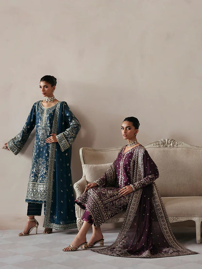 Luxurious raw silk outfit featuring embroidered and sequined panels, elegant chiffon dupatta with organza motifs, and matching dyed silk trouser.