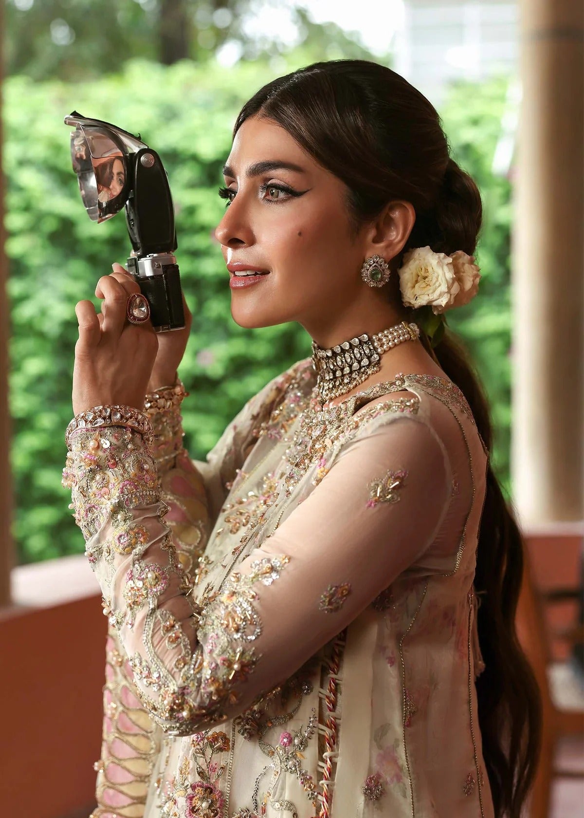 Ethereal ivory frost suit with hand-embellished organza panels, ornate borders, embroidered dupatta, and printed trouser for timeless elegance.