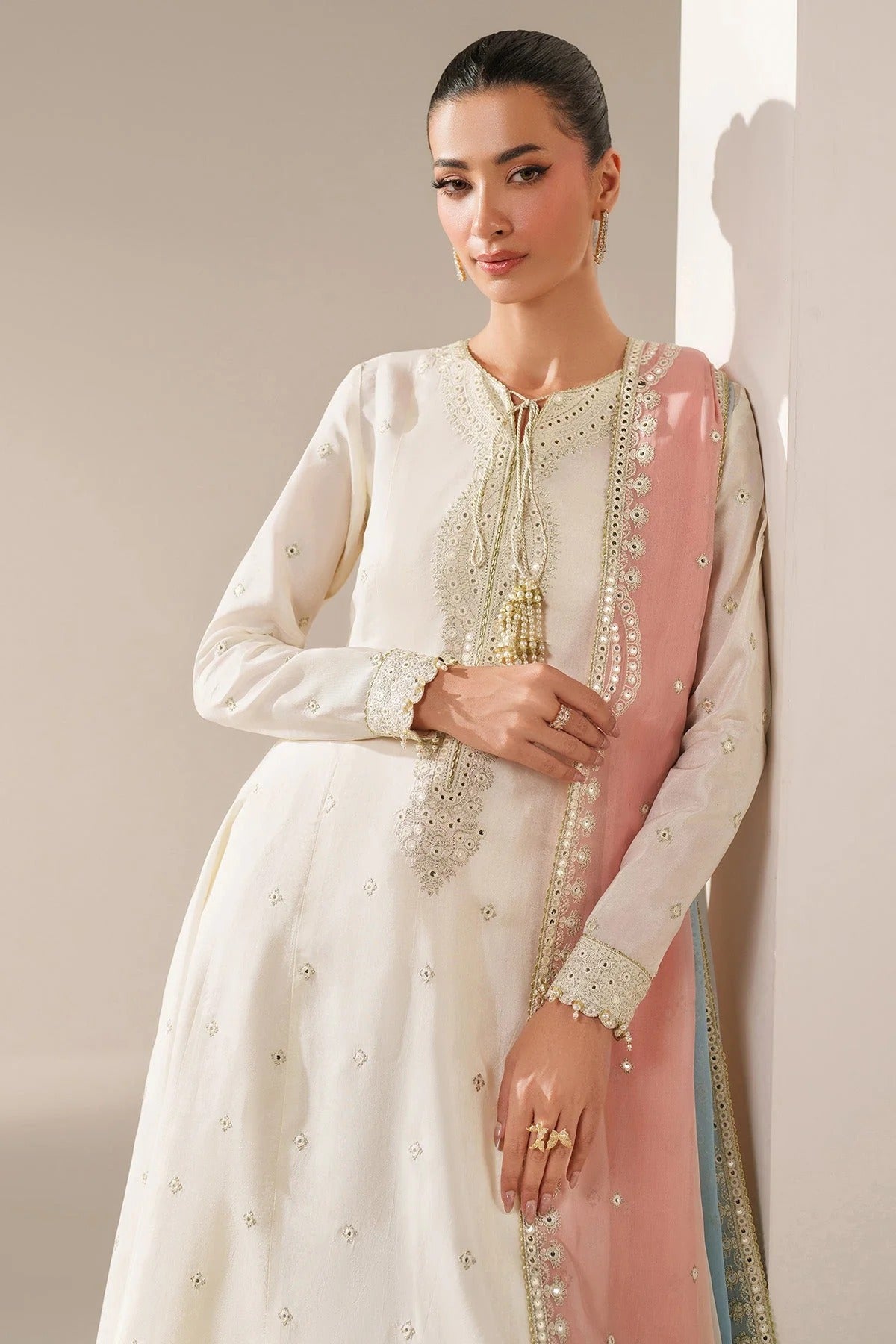 Digitally printed chiffon suit with embroidery on yoke, panels, sleeves & dupatta. Paired with dyed rawsilk bottom for a luxe, elegant formal look.