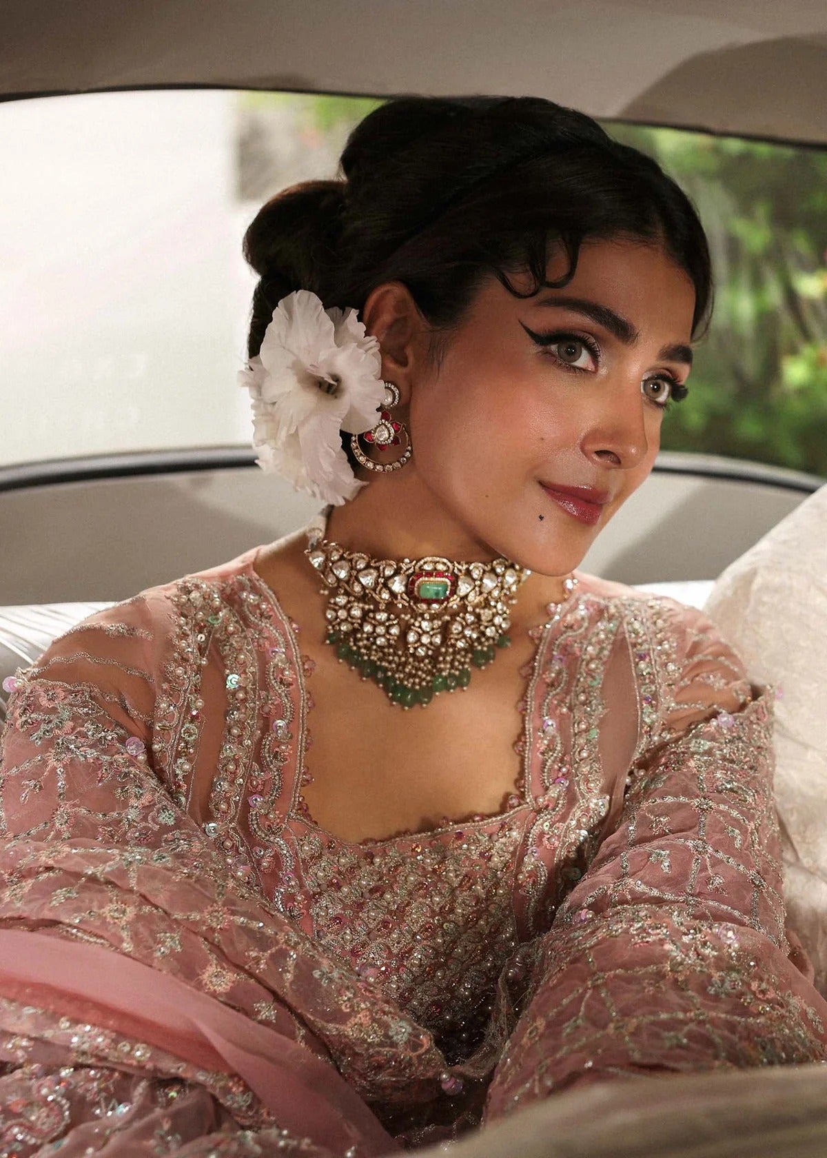 Ethereal blush rose suit with hand-embellished organza panels, ornate borders, and embroidered dupatta. A timeless choice for festive elegance.