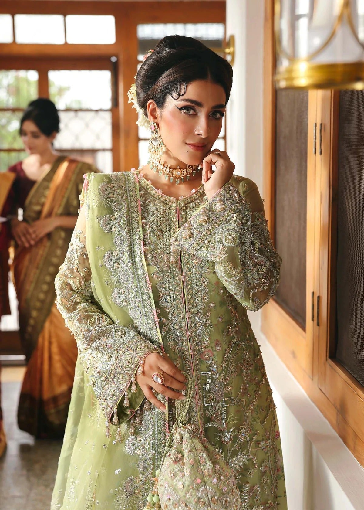 Vibrant parrot jade suit with hand-embellished organza panels, embroidered dupatta, and printed trouser—perfect for festive elegance.