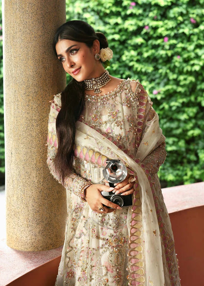 Ethereal ivory frost suit with hand-embellished organza panels, ornate borders, embroidered dupatta, and printed trouser for timeless elegance.