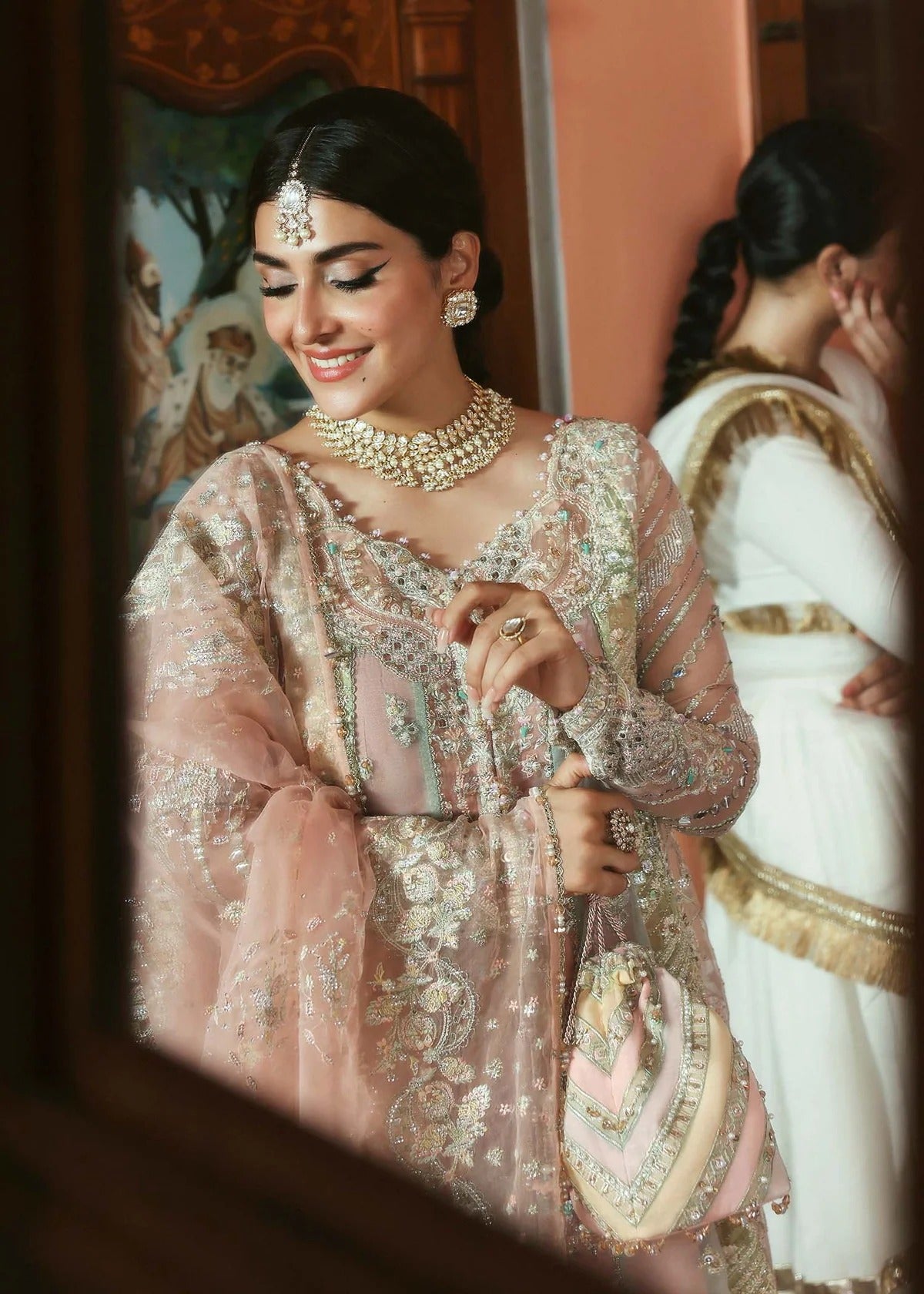Stunning jewel-toned lehenga suit with hand-embellished shirt, embroidered borders, and organza dupatta for a regal festive look.