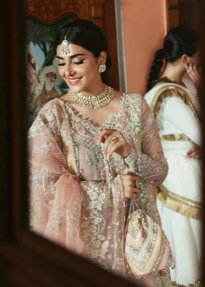 Stunning jewel-toned lehenga suit with hand-embellished shirt, embroidered borders, and organza dupatta for a regal festive look.