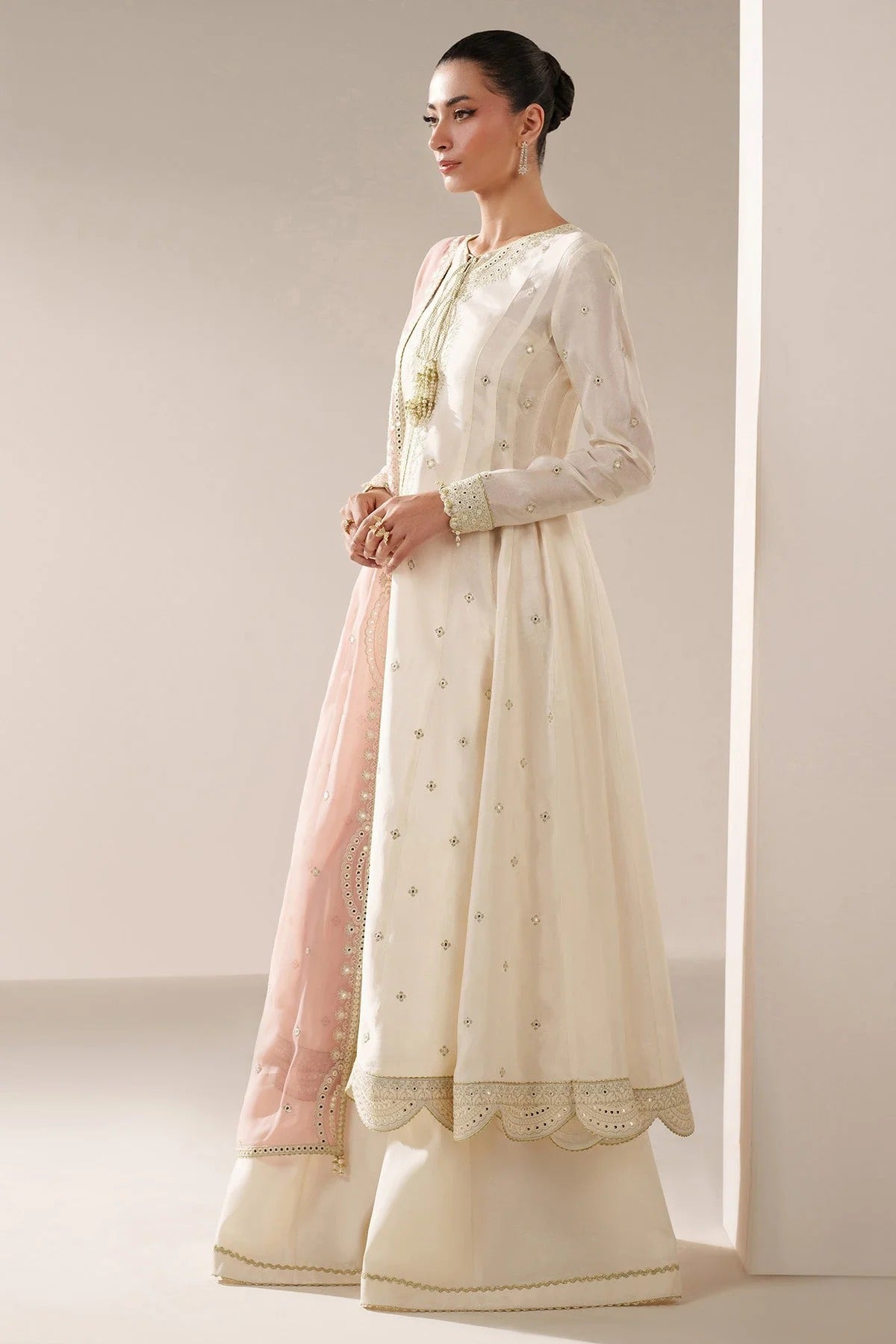 Digitally printed chiffon suit with embroidery on yoke, panels, sleeves & dupatta. Paired with dyed rawsilk bottom for a luxe, elegant formal look.