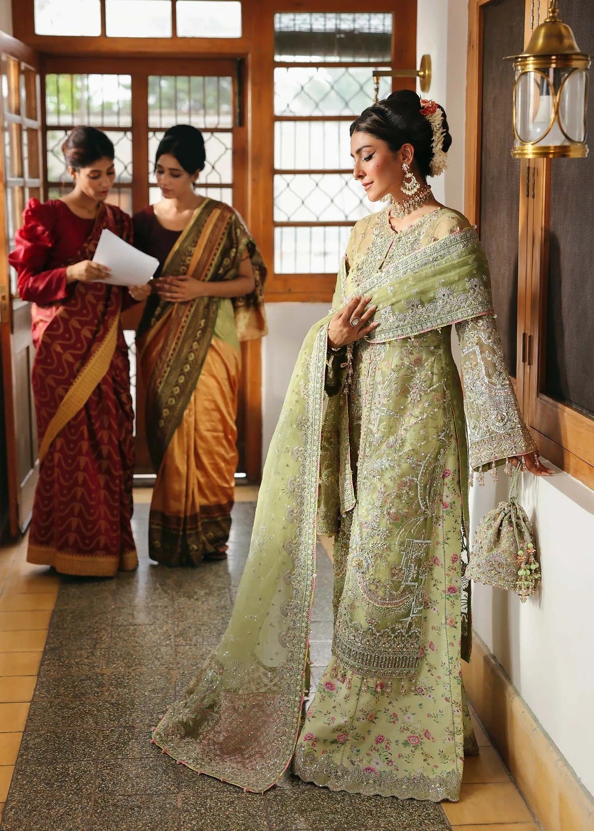 Vibrant parrot jade suit with hand-embellished organza panels, embroidered dupatta, and printed trouser—perfect for festive elegance.