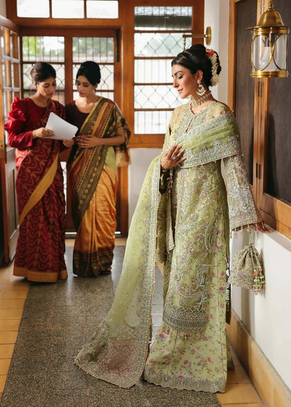 Vibrant parrot jade suit with hand-embellished organza panels, embroidered dupatta, and printed trouser—perfect for festive elegance.