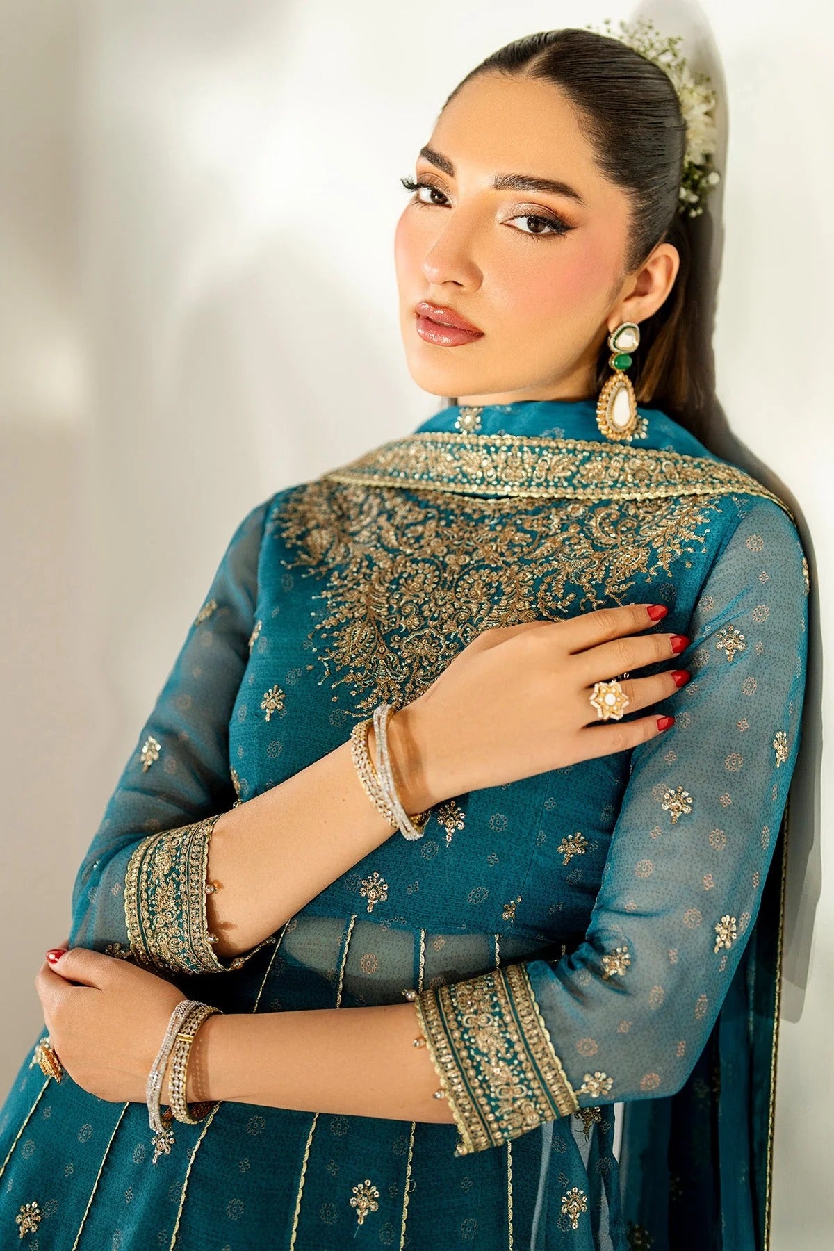 Digitally printed chiffon suit with embroidery on yoke, panels, sleeves & dupatta. Paired with dyed rawsilk bottom for a luxe, elegant formal look.