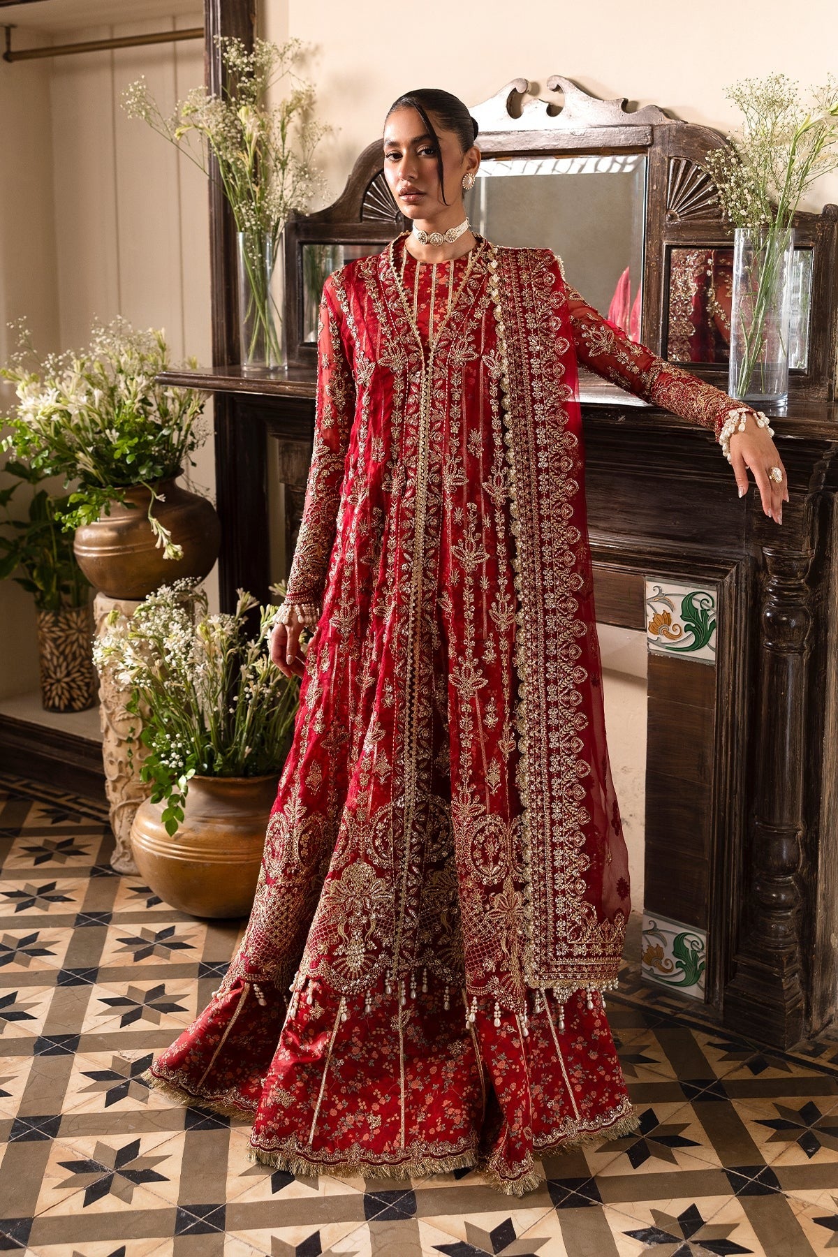 Striking red organza outfit with rich embroidery, dupatta, printed inner shirt, and embroidered trousers. A bold choice for weddings or festive events.