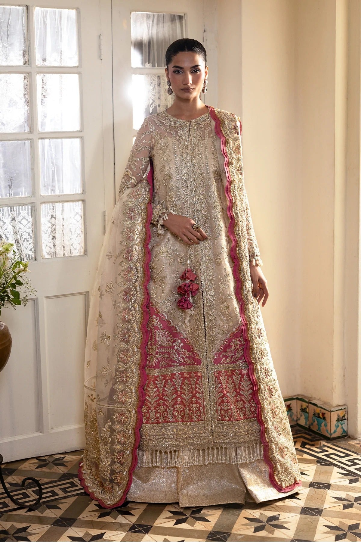 Graceful off-white organza dress with fine embroidery, dupatta, coral & pink borders, and jamavaar trousers. Perfect for elegant festive occasions.