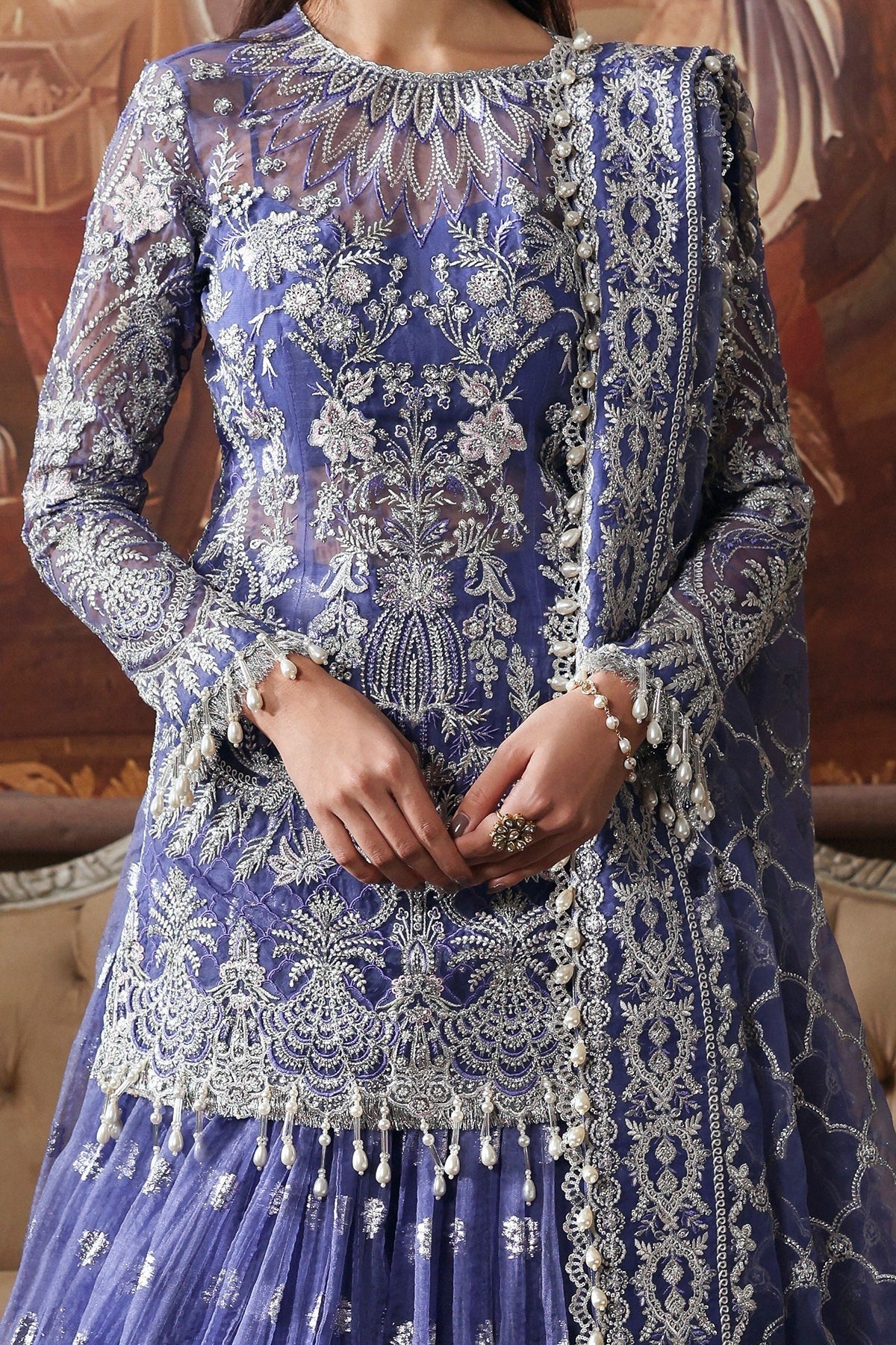 Elegant blue organza dress featuring intricate embroidery, detailed dupatta borders, and dyed trousers. A graceful pick for festive or formal events.