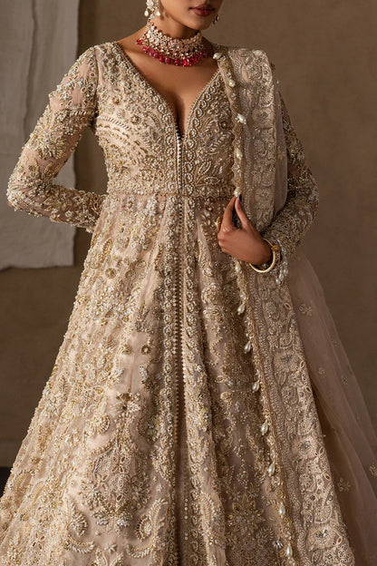 Majestic champagne bridal lehenga with hand embellishment and antique gold embroidery. Features ornate motifs, flowing skirt and elegant dupatta.