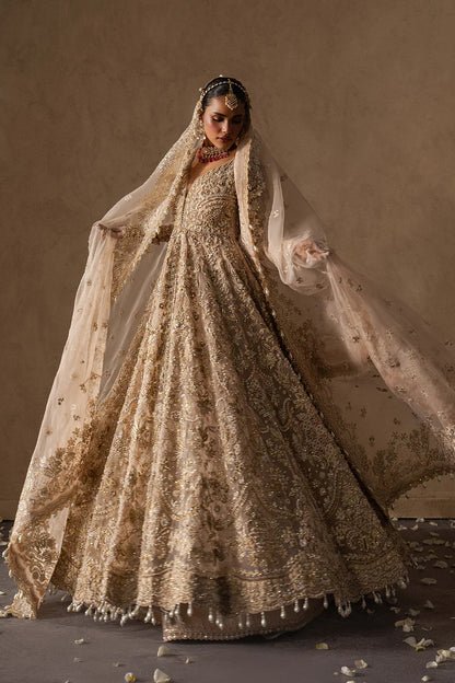 Majestic champagne bridal lehenga with hand embellishment and antique gold embroidery. Features ornate motifs, flowing skirt and elegant dupatta.