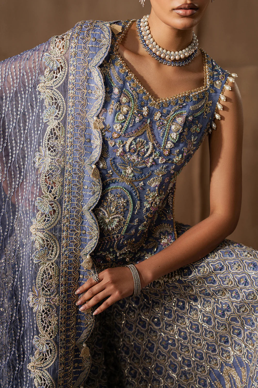 Majestic sapphire sharara set with intricate hand embellishment and metallic embroidery. Paired with an elegant dupatta for a bold festive look.