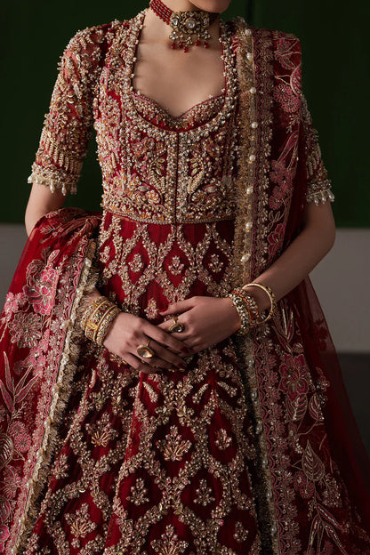 Opulent magenta bridal lehenga with intricate hand embellishment and antique embroidery. Paired with a richly detailed sheer dupatta.