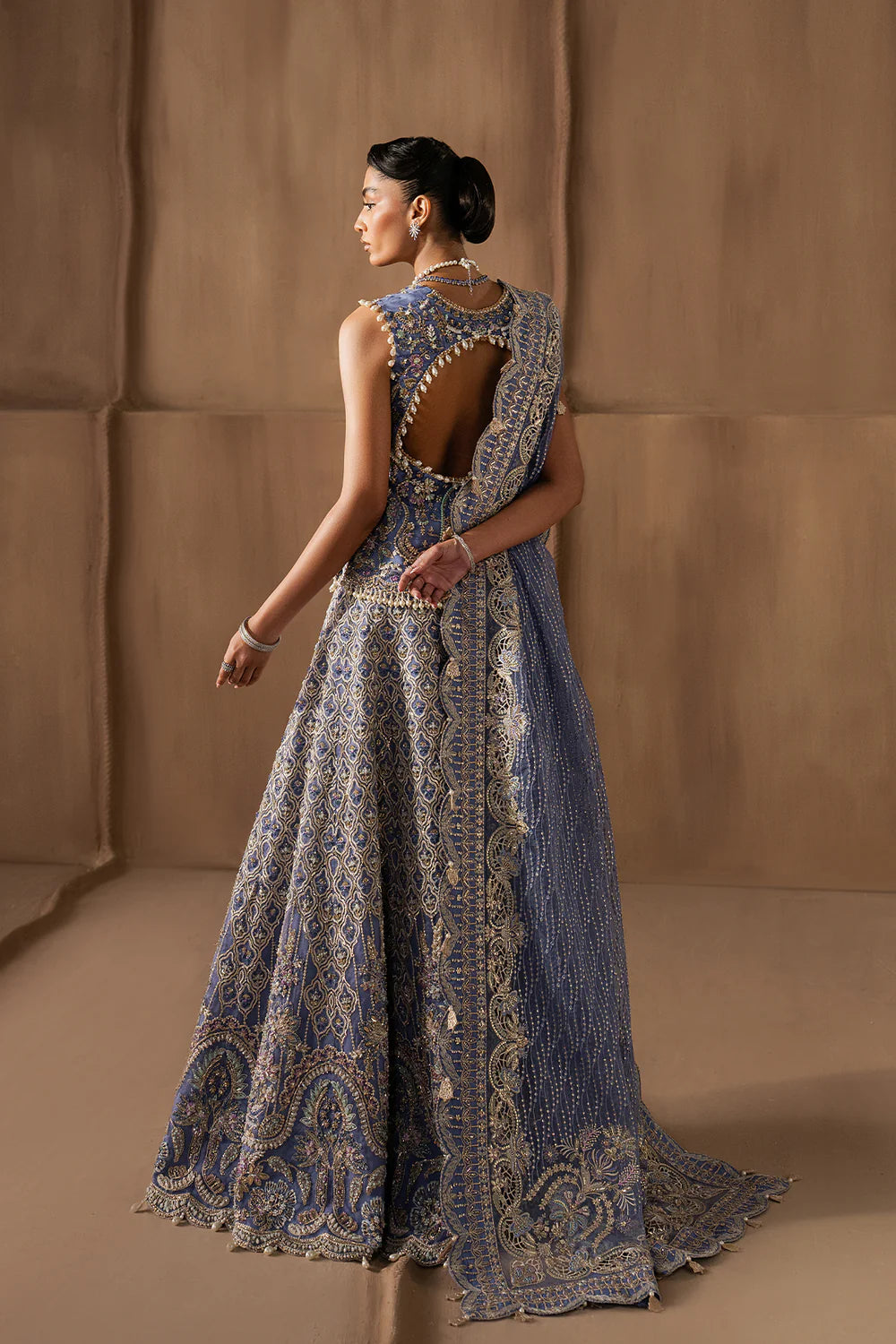 Majestic sapphire sharara set with intricate hand embellishment and metallic embroidery. Paired with an elegant dupatta for a bold festive look.