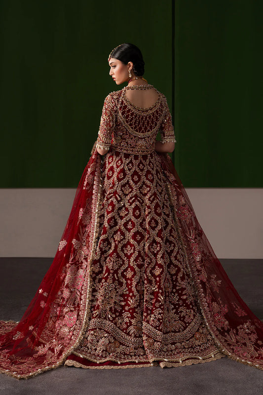 Stunning wine red bridal lehenga with dense hand embellishment and antique gold embroidery. Paired with a richly embroidered sheer dupatta.