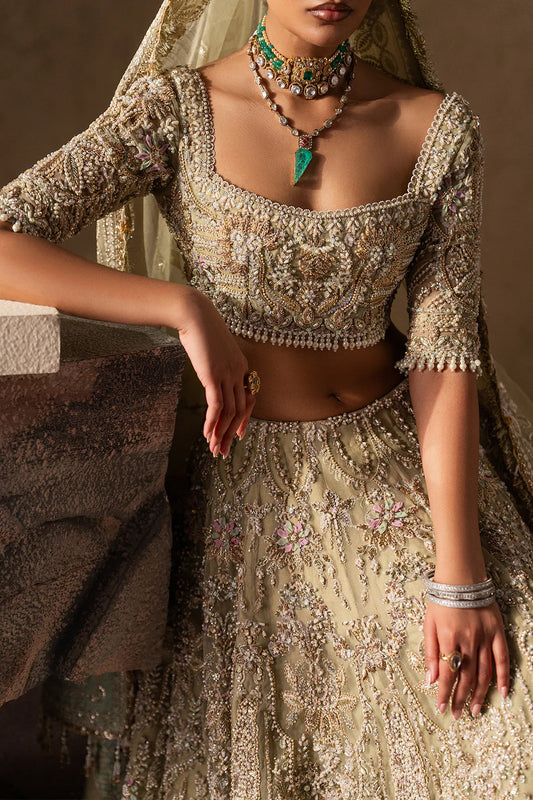 Elegant pastel gold bridal lehenga with intricate hand embellishment, paisley and floral motifs. Paired with a sheer dupatta for a timeless look.