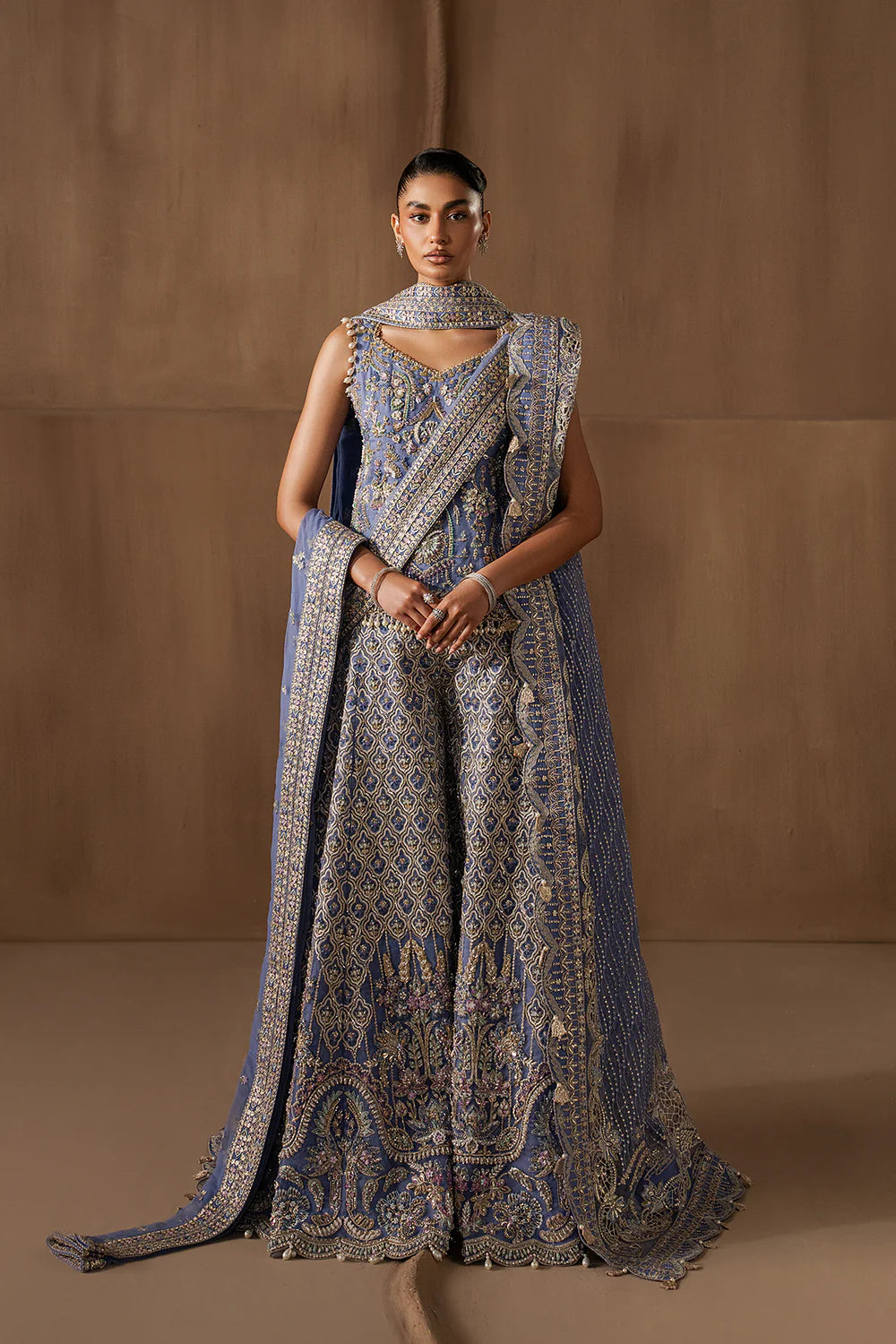 Majestic sapphire sharara set with intricate hand embellishment and metallic embroidery. Paired with an elegant dupatta for a bold festive look.