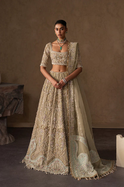 Elegant pastel gold bridal lehenga with intricate hand embellishment, paisley and floral motifs. Paired with a sheer dupatta for a timeless look.